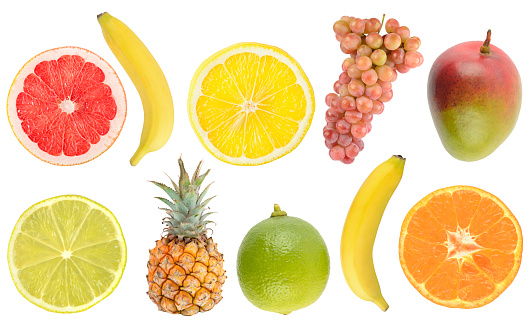 Fresh tropical fruits whole and cut in half isolated on white background.