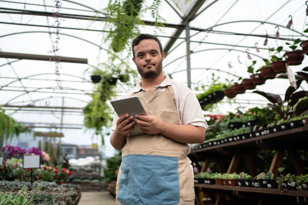 istock Portrait of a young special needs using digital tablet in a garden center 1466802608