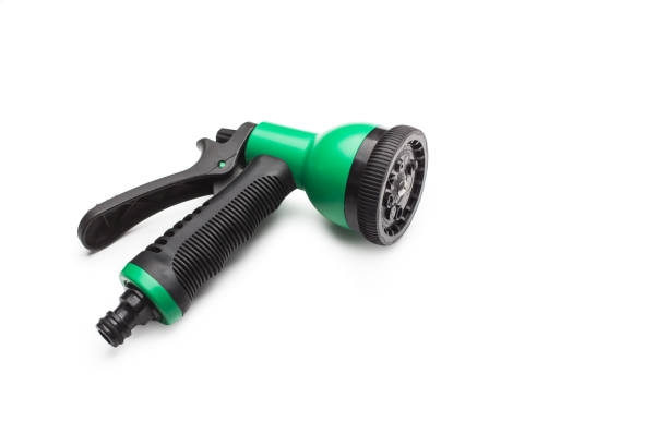 istock Green and black plastic watering gun on a white background 1466803137