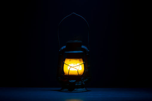Vintage lantern on blue background. Still life