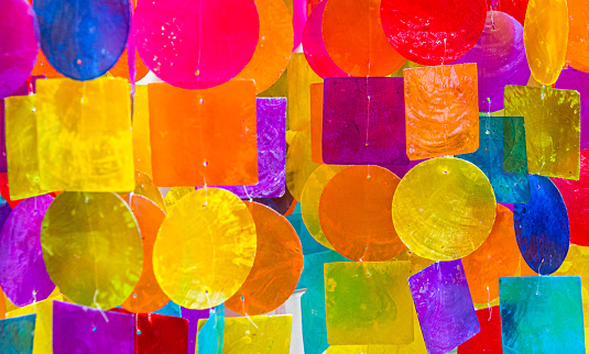 Close up abstract colors of a display of windchimes.