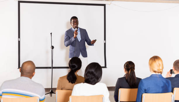 istock Male coach giving speech at conference hall 1466816363
