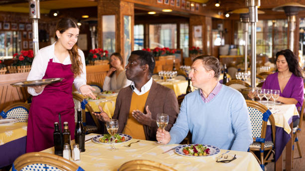 istock Waitress and two man of the restaurant pay for dinner using smartphones 1466816610