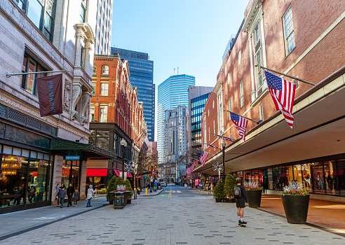 Boston, Massachusetts, USA - February 11, 2023: A view down Summer Street (est. 1708) extending from the Downtown Crossing area with its retail stores to the tall modern office buildings of the Financial District.