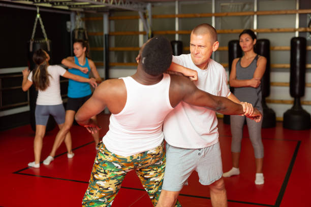 istock Men and women exercising during self-protection training 1466818462
