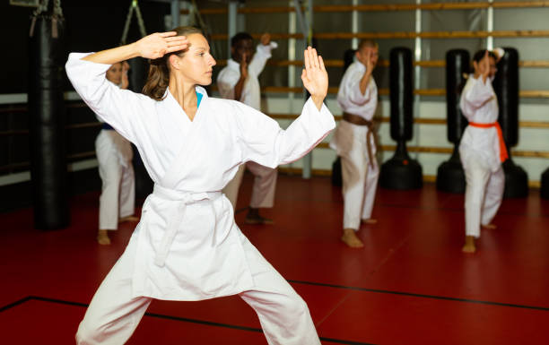 istock Woman in kimono showing fight stance during karate training 1466818528
