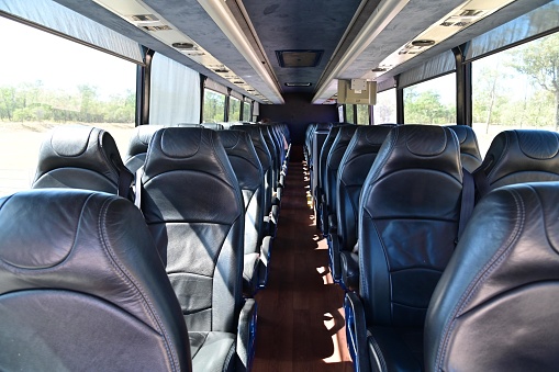 Interior view of empty bus seats background.