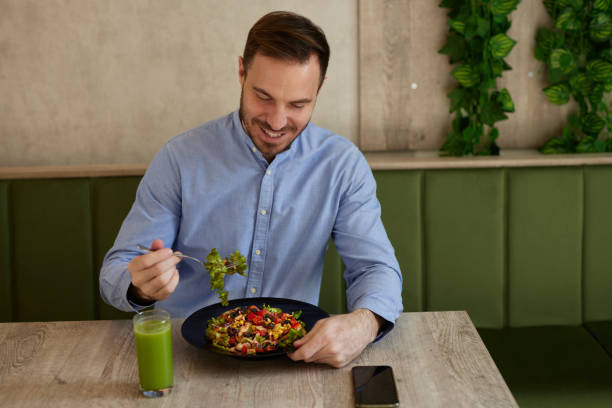 istock Man eating salad in the salad bar 1466827110