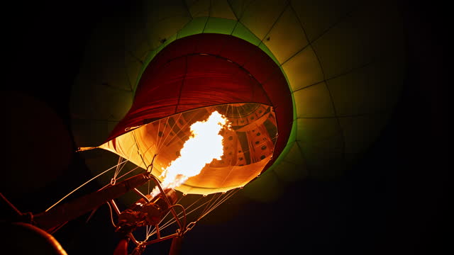 Propane igniting and filling hot air balloon in dark