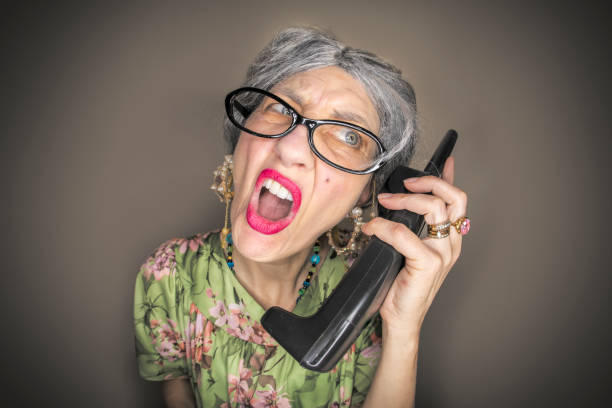 Young woman with vintage phone looking surprised