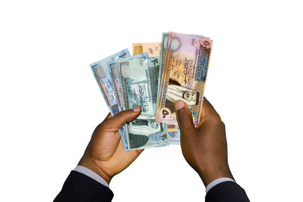 istock Black Hands in suit holding 3D rendered Jordanian dinar notes 1466834165