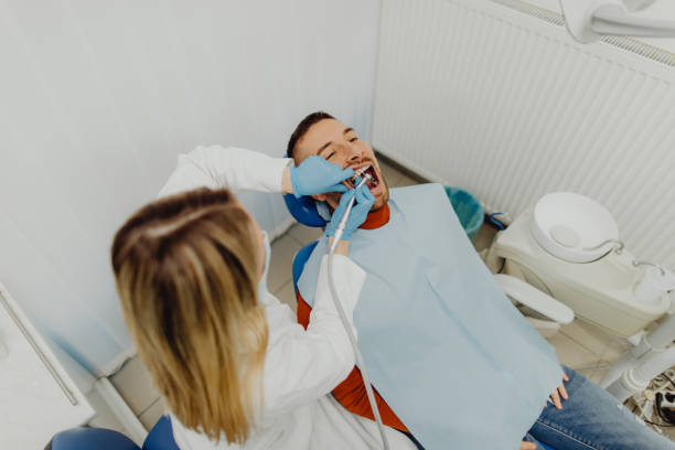 Doctor checking up patient at dentist office stock photo