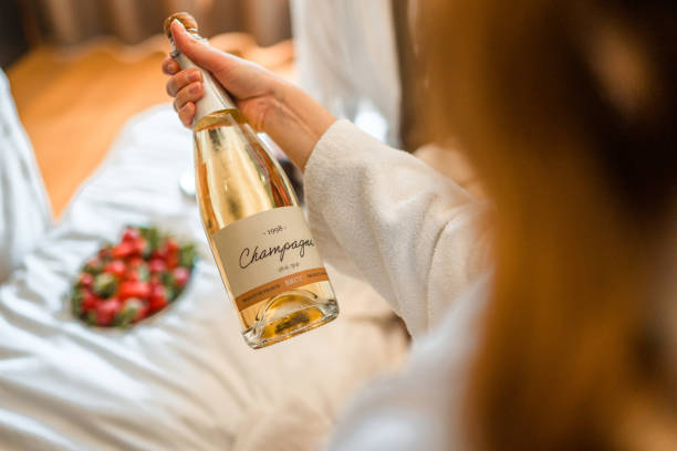 Woman Holding A Champagne Bottle stock photo