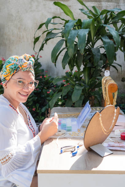 istock Woman making necklaces in her home workshop. 1466838846