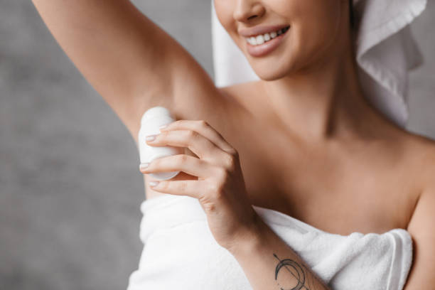 istock Happy caucasian lady applying roller deodorant to armpit zone while making daily beauty routine in bathroom 1466839657