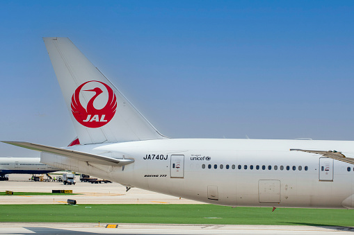 Tail of Japan Airlines Boeing 777-346ER aircraft with registration JA740J taxiing at Chicago O'Hare International Airport in May 2022.