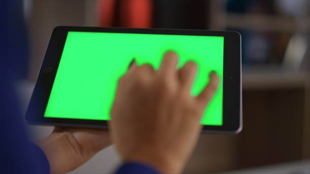 istock Businesswoman hands surfing internet data using tablet chroma key in home office 1466842943