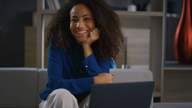 istock Relaxed corporate woman looking camera smiling posing in home office workplace. 1466843783