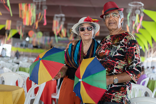 Portrait of senior couple wearing costume at carnival ball