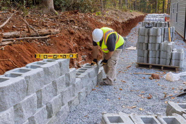istock There was a worker on a construction site installing a concrete block for a retaining wall near a new house that was being built 1466849662