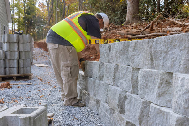istock During the construction of a new home at a near a construction site, a construction worker was laying concrete blocks for a retaining wall. 1466849663