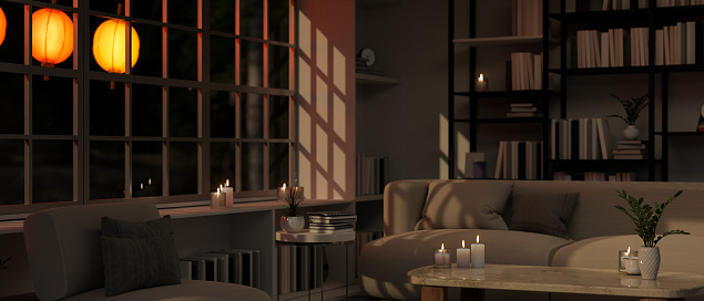 Modern and comfortable home living room at night interior design with cozy couch, burning candles, coffee table, bookcase against the window with Chinese lanterns. 3d render, 3d illustration