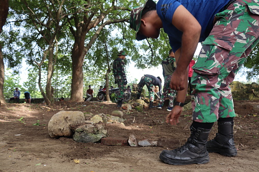 Indonesian Army troops carry out mutual cooperation cleaning and arrangement of the ancient 18th century Aceh royal tombs in Alue Deah Tunong Village, Meuraxa District, Banda Aceh City