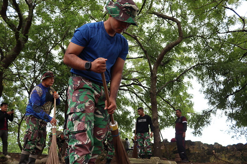 Indonesian Army troops carry out mutual cooperation cleaning and arrangement of the ancient 18th century Aceh royal tombs in Alue Deah Tunong Village, Meuraxa District, Banda Aceh City