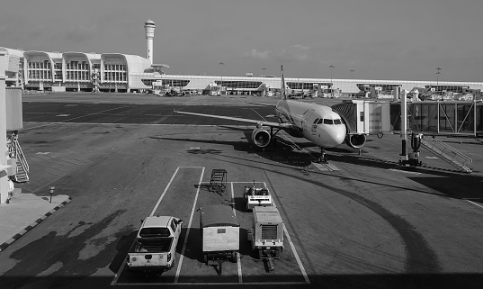 View of Munich Airport from the plane in black and white, view of the surroundings, buildings, hangars and planes on the ground