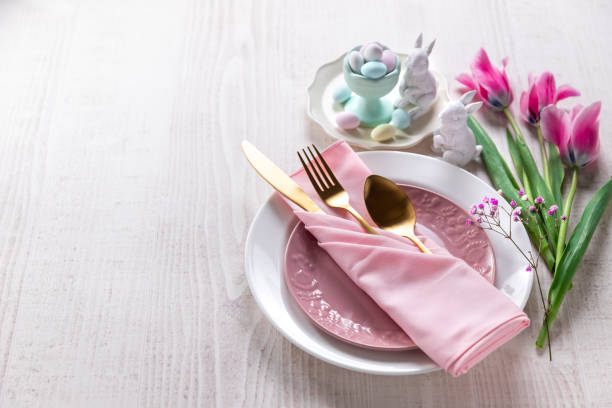 Happy Easter pink table place setting stock photo