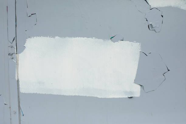 White paint on grey wall. Paint spot white. Smeared inscription. Poor wall painting.