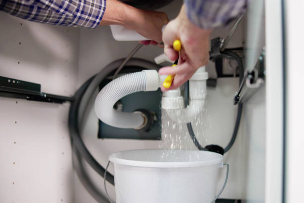 istock Male Plumber Repairing White Sink Pipe 1466896062
