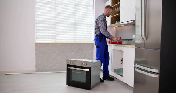 istock Young Repairman Installing Induction Cooker 1466896208