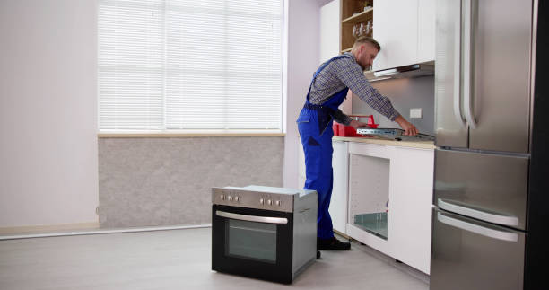 istock Young Repairman Installing Induction Cooker 1466896223