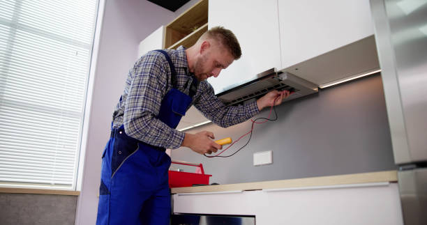 istock Male Worker In Overall Testing Kitchen Hood With Multimeter 1466896254