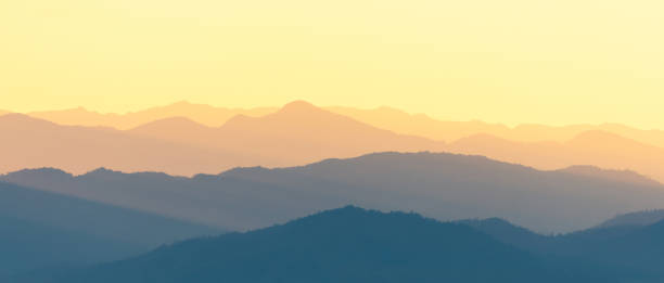 istock Panoramic scene of bright sunlight over the layers of mountain range. 1466900476