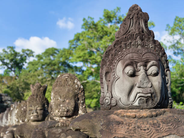 stone face cambodia angkor wat south gate khmer sculptures detail - wat angkor thom imagens e fotografias de stock