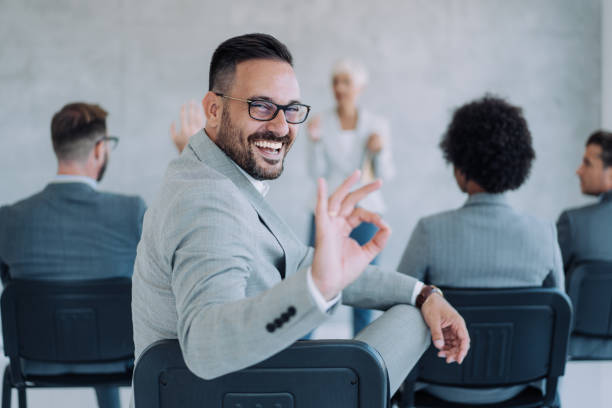 Confident businessman attending a seminar.