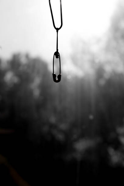 istock a safety pin hanging towards the window 1466905429