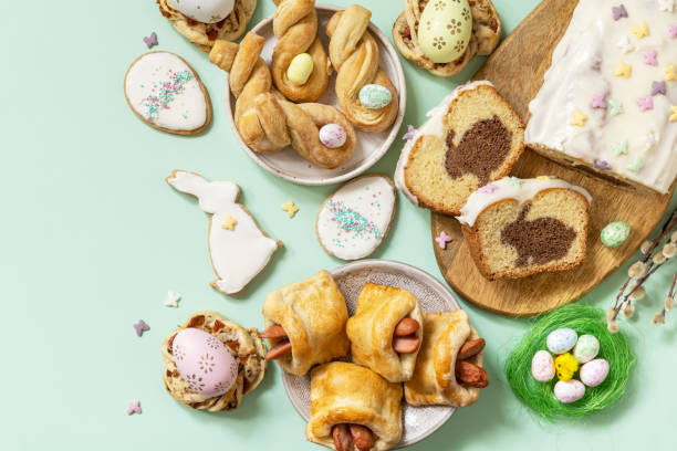 istock Festive dinner, Easter brunch. Happy Easter holiday food baking puff pastry and cupcake with Easter Bunny on pastel green background. View from above. Copy space. 1466906716