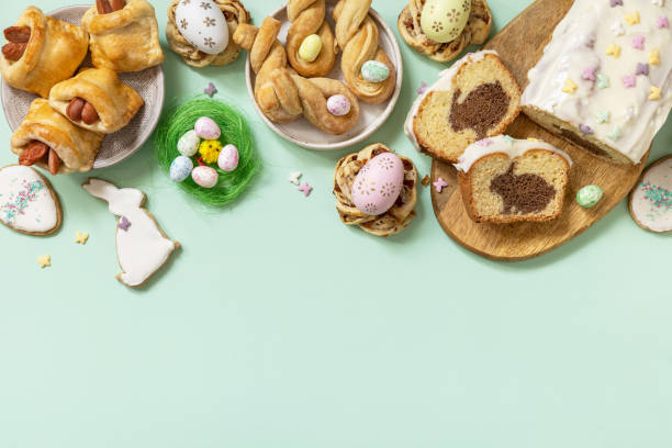 istock Festive dinner, Easter brunch. Happy Easter holiday food baking puff pastry and cupcake with Easter Bunny on pastel green background. View from above. Copy space. 1466906717