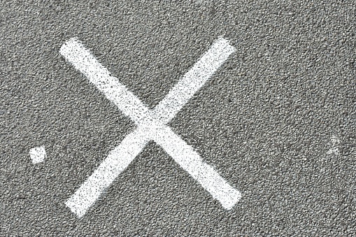 Cross sign on road