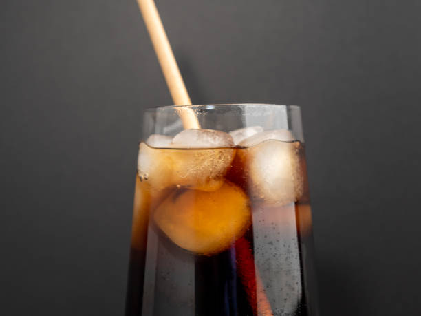 istock Glass of cola with ice on a black background. 1466910504