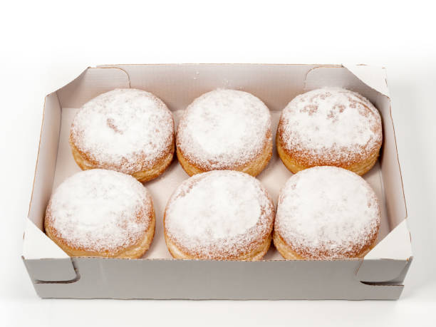 istock Freshly baked and dusted with powdered sugar German donuts. 1466918500