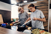 Mother and son preparing breakfast together