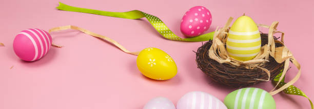 istock Easter eggs painted in pastel colors on pink background. Easter concept. Banner 1466928280