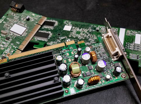 Electronic computer board with its components, on a dark background.