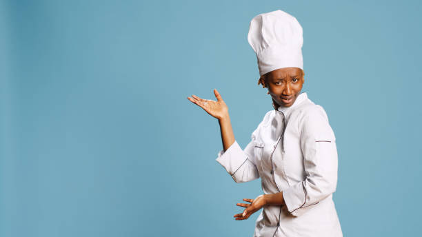 istock Professional cook in apron pointing left or right sides 1466929172
