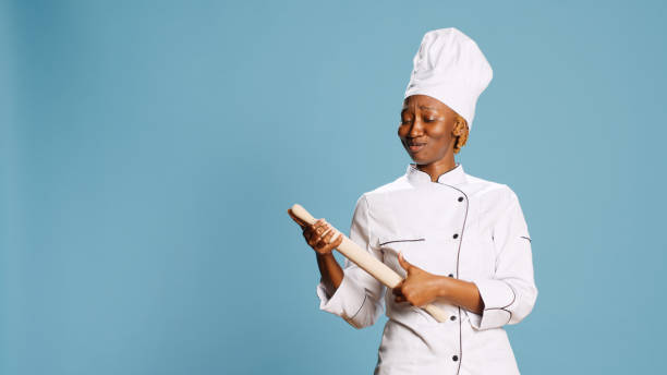 istock Cheerful funny chef playing with rolling pin and singing 1466929293