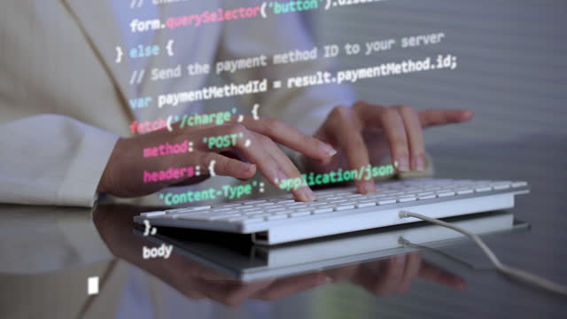 Close-up of hands typing coding programming JavaScript language.